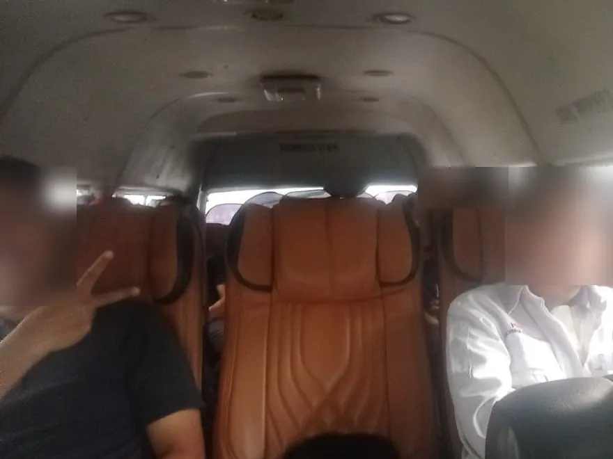 Passengers seated in the tour van