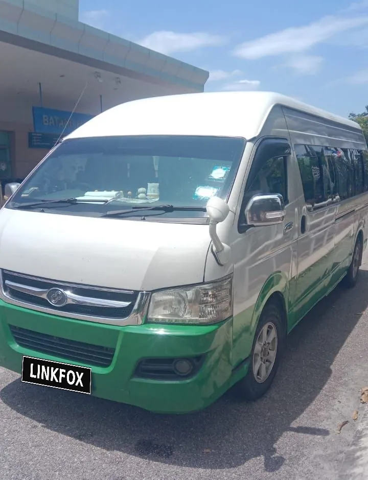 Green and white tour van ready for pickup